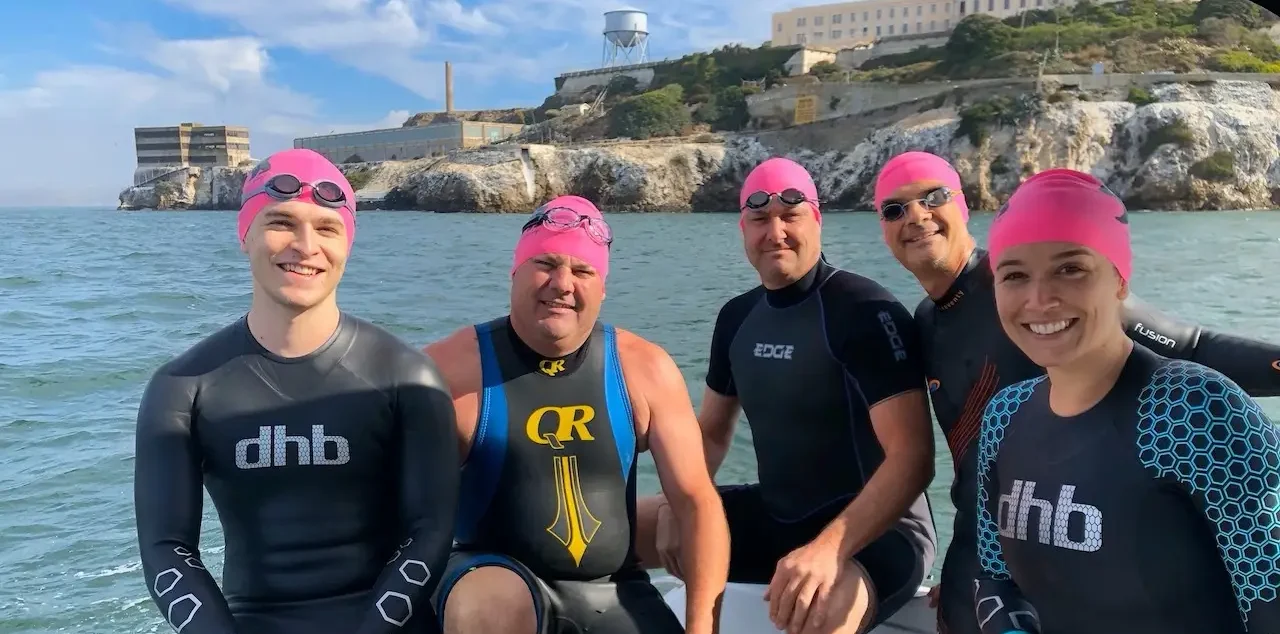 five triathletes about to jump off the boat at Alcatraz and swim the Escape to SF